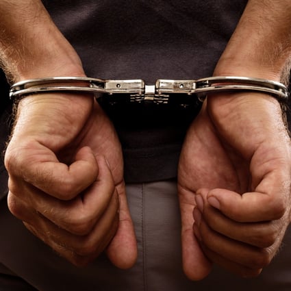 Arrested man handcuffed hands at the back. Photo: Shutterstock/File