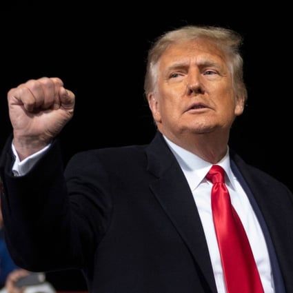 US President Donald Trump holds up his fist as he leaves the stage at the end of a rally in Valdosta, Georgia, in December 2020. Photo: AFP via TNS
