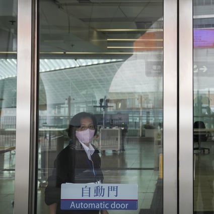 A security guard on duty at  Hong Kong West Kowloon Railway Station. Some 46,000 to 87,000 workers, mostly security guards and cleaners, will benefit when the city’s new wage floor comes into effect in May. Photo: Sam Tsang