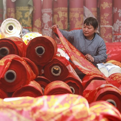 A worker checks cloth at a textile factory in China’s Zhejiang province, where authorities say they will “exhaust all measures to push for export growth” this year. Photo: AFP