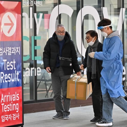 A health worker guides travellers arriving from China at a Covid-19 testing centre at Incheon International Airport in South Korea on January 3. Photo: AFP