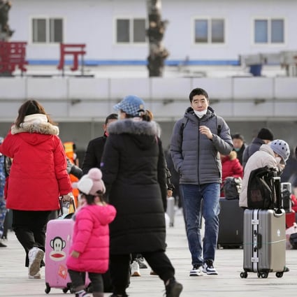 A street in front of Beijing station is crowded with travelers ahead of China’s Lunar New Year holidays later in the month.  Photo: Kyodo