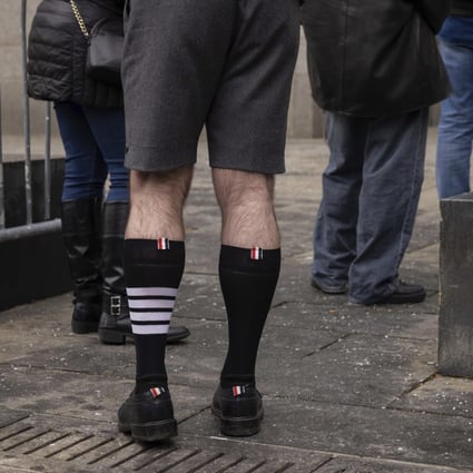 Fashion designer Thom Browne wears socks from his label with four stripes outside a federal court in Manhattan, New York, that was hearing Adidas’ case against his brand over use of the stripes. A jury found in his favour on Thursday. Photo: AP 