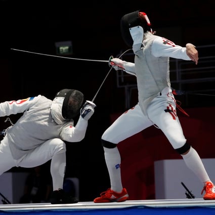 Nicholas Choi (right) against Huang Mengkai of China in the individual foil final at the 2018 Asian Games. Photo: Reuters 