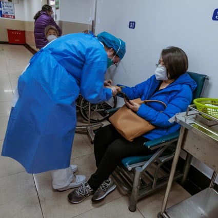 Medical personnel attending to a patient at a hospital in Shanghai on Friday. China says the number of Covid-19 infections across the country is waning. Photo: EPA-EFE