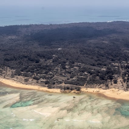 Volcanic ash covers roof tops and vegetation in an area of Tonga in January 2022, days after the eruption of the underwater Hunga Tonga-Hunga Ha’apai volcano. Photo: NZDF via AP