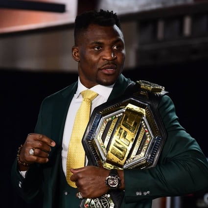 Champion Francis Ngannou holds the championship belt in the press room after defeating fellow Frenchman Cyril Gane on January 22, 2022. Photo: AFP