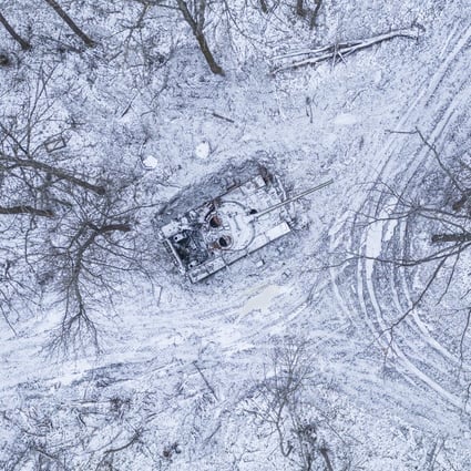 A destroyed Russian tank covered by snow in a forest in the Kharkiv region, Ukraine. Photo: Reuters