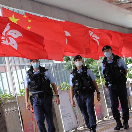 The Chinese and city flags on a footbridge in Hong Kong. Under the Basic Law, Hong Kong is required to enact its own version of the national security law. Photo: Jelly Tse