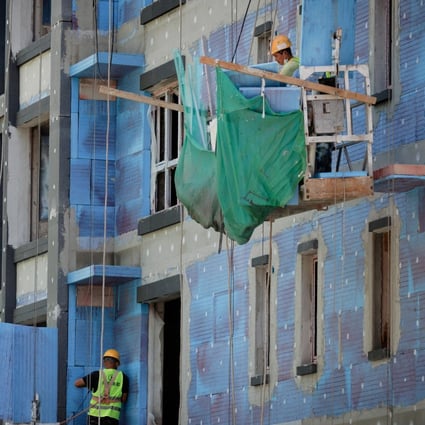 Men work at a residential construction site in Beijing. China has unveiled a slew of measures to revive the country’s real estate sector. Photo: Reuters