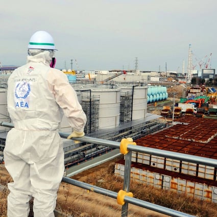 A member of an International Atomic Energy Agency inspection team looks out over the Fukushima Daiichi Nuclear Power Station. Japan has approved release of more than 1 million tonnes of water from the destroyed power plant. Photo: International Atomic Energy Agency Handout via AFP