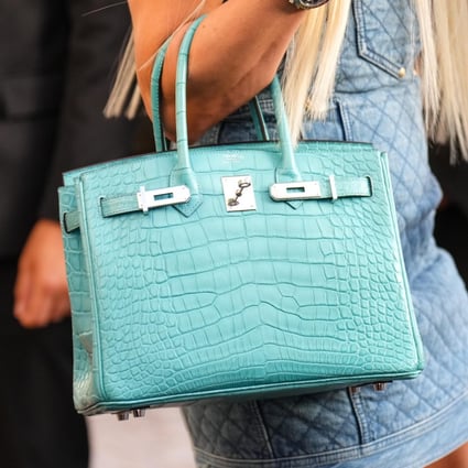 A guest carries a blue crocodile skin Birkin handbag from Hermès during the Cannes Film Festival in 2022. Demand for exotic skin bags remains strong even as some brands move away from them. Photo: GC Images
