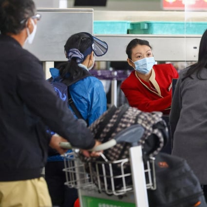 A Cathay employee helps passengers at Hong Kong International Airport. Photo: Dickson Lee