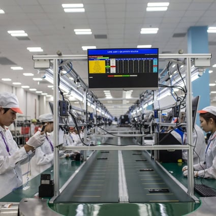 Workers perform quality checks on Vsmart smartphones on the production line at the VinSmart factory, operated by Vingroup JSC  in Hanoi. Photo: Bloomberg