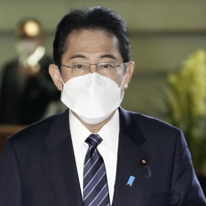 Japan’s Prime Minister Fumio Kishida arrives at his office in Tokyo Friday to announce preparations for downgrading the legal status of Covid-19. Photo: AP