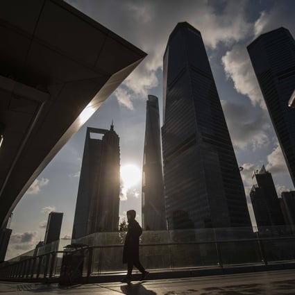A pedestrian walks in Pudong’s Lujiazui Financial District in Shanghai on January 3, 2023. Photo: Bloomberg