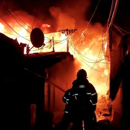 Firefighters work to extinguish the blaze at Guryong village, the last slum in Seoul’s glitzy Gangnam district, on Friday morning. Photo: South Korea’s National Fire Agency/Yonhap via Reuters