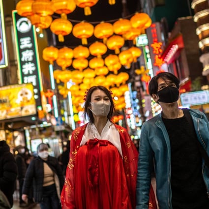 People walk underneath lanterns in the Chinatown section of Yokohama, south of Tokyo, on January 15, 2023, ahead of the Lunar New Year. Photo: AFP