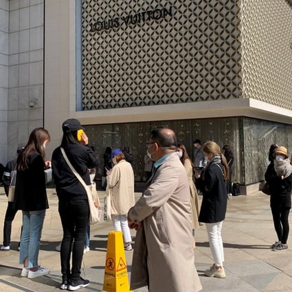 Customers queue to enter a luxury brand boutique at a department store in Seoul, South Korea. File photo: Reuters