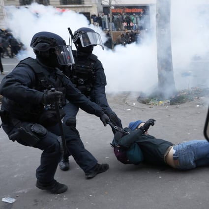 Riot police officers grab a protester during a demonstration against pension changes in Paris, France on Thursday. Photo: AP 