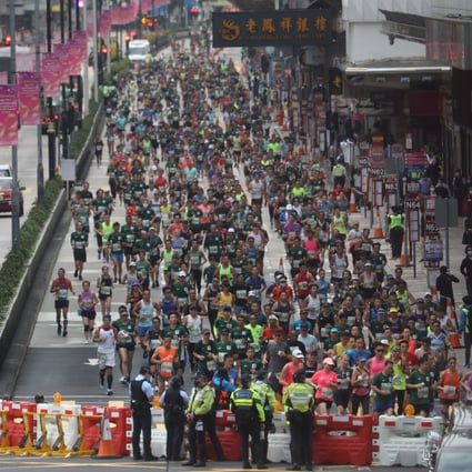 Participants run through Nathan Road in Mong Kok during the 2021 Standard Chartered Hong Kong Marathon. Photo: Winson Wong