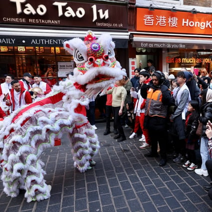 A lion dance is performed in the streets of Chinatown for the Chinese Lunar New Year in London. Photo: Reuters