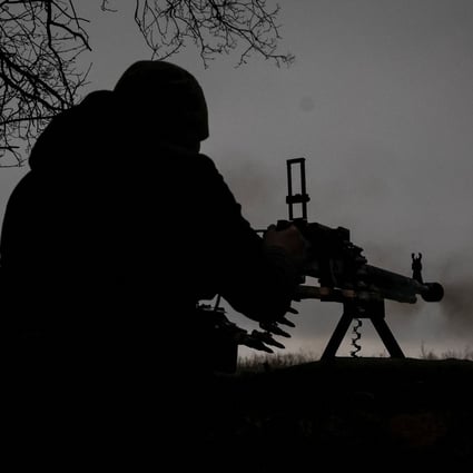 A Ukrainian service member fires a machine gun at a position on the front line near the town of Soledar on January 14. Photo: Radio Free Europe/Radio Liberty via Reuters