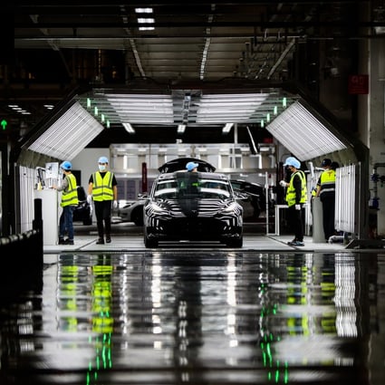 Tesla employees are seen at the assembly line inside the US company’s Gigafactory 3 complex in Shanghai on November 20, 2020. Photo: Xinhua