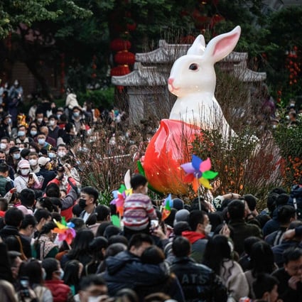People visit a traditional Spring Festival flower market in Guangzhou on January 20. China’s reopening and the prospect of unleashing years of pent-up consumer demand have turned markets bullish, but the strength and durability of China’s upturn remains in doubt. Photo: AFP