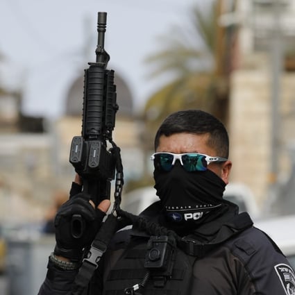 A police officer closes the area in Jerusalem where two Israeli’s were shot and wounded a day after deadly attack on a synagogue. Photo: dpa