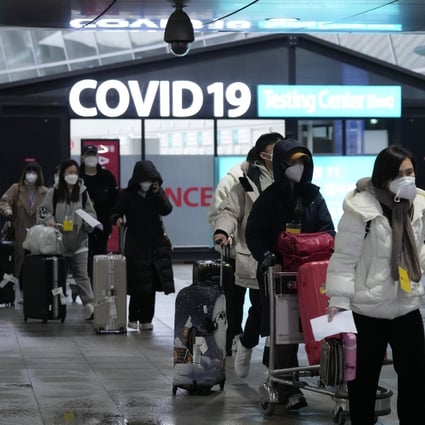 Passengers arriving from China pass by a Covid testing centre at Incheon airport in South Korea on January 14. Photo: AP
