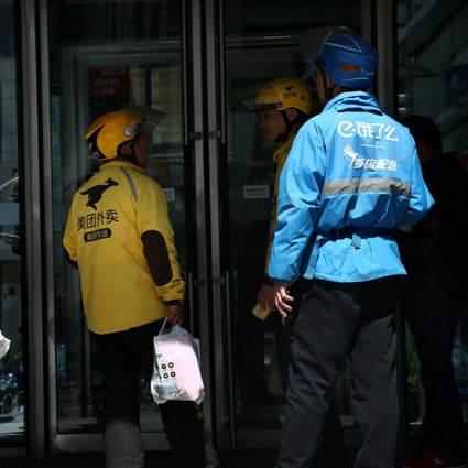 Drivers of food delivery service Ele.me (in blue) and Meituan (in yellow) seen in Beijing on April 11, 2018. Photo: Reuters