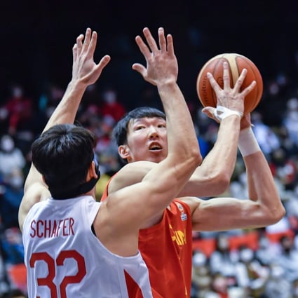 China’s Zhou Qi (right) looks to take shot over Japan’s Schafer Avi Koki during a Fiba Basketball World Cup qualifier. Photo: Xinhua