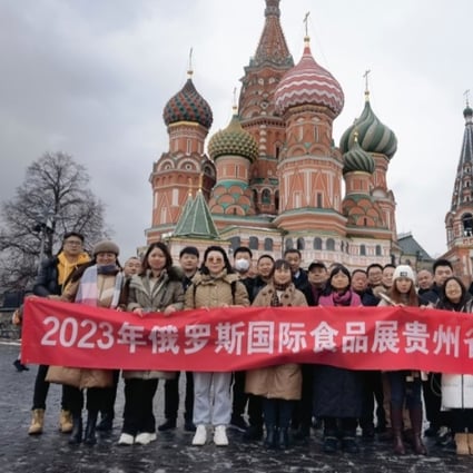 The business delegation from  Guizhou province poses in front of St Basil’s Cathdral in Moscow’s Red Square. Photo: Weibo 