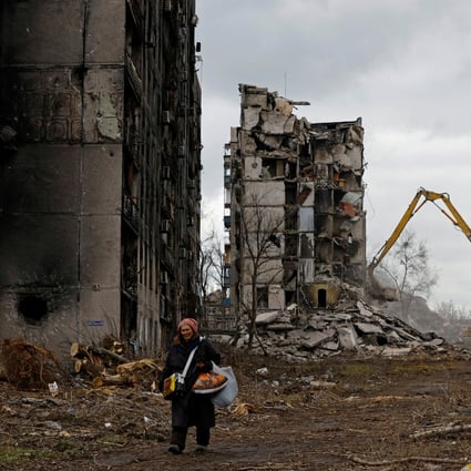 A woman walks past destroyed apartment blocks in her neighbourhood in Mariupol in Russian-controlled Ukraine, on February 15. Photo: Reuters