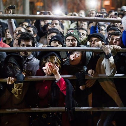 Iranian women react during the execution of two men in Tehran in 2013. File photo: AP