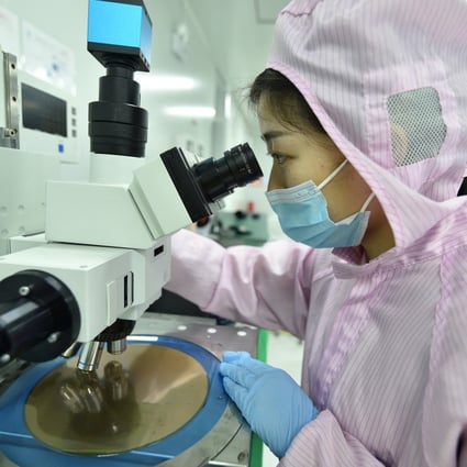 An employee inspects a wafer at the production line of a semiconductor chip company in Suqian, Jiangsu province, on February 28. Semiconductors have emerged as the latest front of competition between China and the United States, putting progress on globalisation and the underpinnings of global trade under unprecedented threat. Photo: Reuters