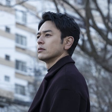 Satoshi Tsumabuki in a still from A Man (category: IIA Japanese), co-starring Sakura Ando and directed by Kei Ishikawa.