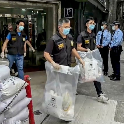 Macau police seize evidence from a hotel room where a woman’s body was found. Photo: Handout