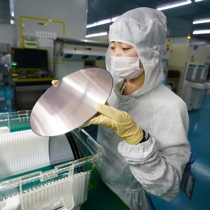 A worker examines a semiconductor wafer at HT-Tech (Nanjing) Co, in east China’s Jiangsu province, March 9, 2023. Photo: Xinhua