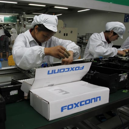 Staff members work on the production line at Foxconn Technology Group’s manufacturing complex in the tech hub of Shenzhen, in southern Guangdong province. Photo: AP