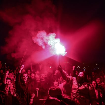 Protesters light flares near the National Assembly in Paris, France on Thursday after President Emmanuel Macron raised the retirement age from 62 to 64. Photo: EPA-EFE