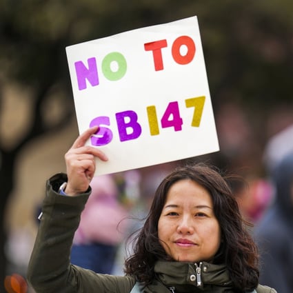 Liu Yang holds a sign in opposition to Texas Senate Bill 147 during a rally on January 29, 2023, in Dallas, Texas. The original bill proposed outlawing real estate/property ownership by people from China, Iran, North Korea and Russia. Photo: The Dallas Morning News/TNS