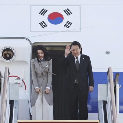 South Korean President Yoon Suk-Yeol waves as his wife Kim Keon-hee bows before departing for Japan at the Seoul military airport in Seongnam. Photo: AP