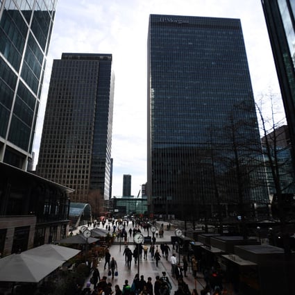 International banks tower over pedestrians in the Canary Wharf financial district, in London, on March 16. Fears are growing of a new global banking crisis following the losses suffered by Credit Suisse and the collapse of US bank SVB. Photo: EPA-EFE