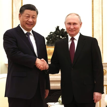 Russian President Vladimir Putin welcomes Chinese leader Xi Jinping before their meeting in Moscow on Monday. Photo: Kremlin via dpa