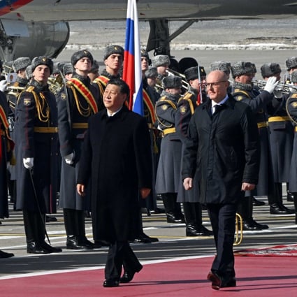 Chinese President Xi Jinping, accompanied by Russian Deputy Prime Minister Dmitry Chernyshenko, walks past honour guards at Moscow’s Vnukovo airport on March 20. Photo: Kommersant / AFP