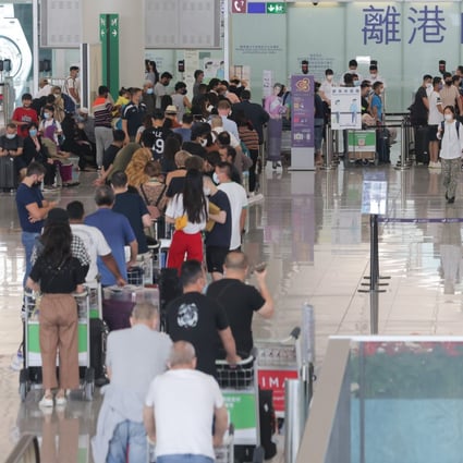 Passengers queue in the departures hall at Hong Kong International Airport on September 21, 2022. The city’s challenge in the face of its latest wave of emigration is to restore a favourable environment at home and give its talented young people a reason to stay. Photo: Jelly Tse
