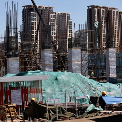 New homes stand behind the construction site of a new subway station in Beijing on April 18, 2023. Photo: Reuters