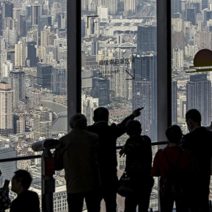 Visitors take in the view from the observation deck at Shanghai Tower. Home sales have been strong in the Greater Bay Area, the Yangtze River Delta area and the Beijing-Tianjin-Hebei region, thanks to demand in tier-1 cities such as Shanghai and Shenzhen. Photo: Bloomberg